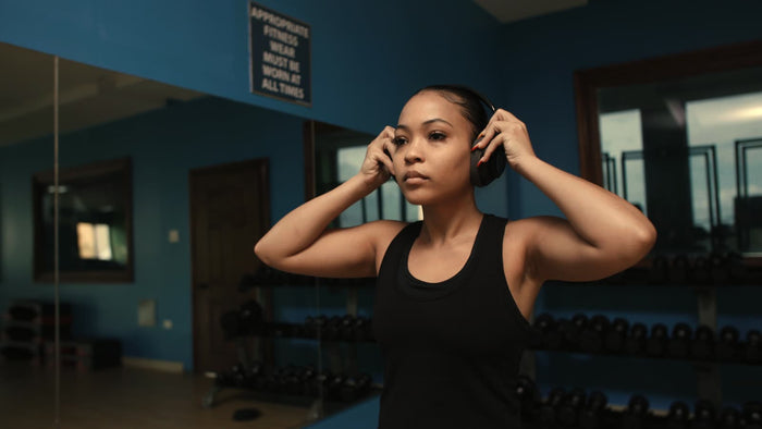 Athlete putting on headphones before a workout