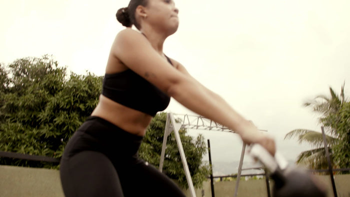 Athlete swinging a kettlebell outdoors
